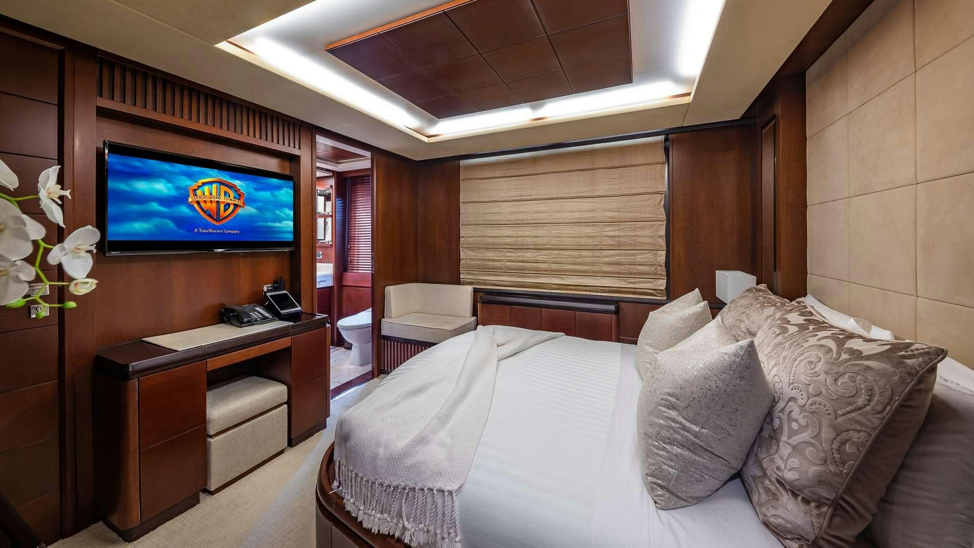 a hotel room with a bed and a tv aboard TAIL LIGHTS Yacht for Charter