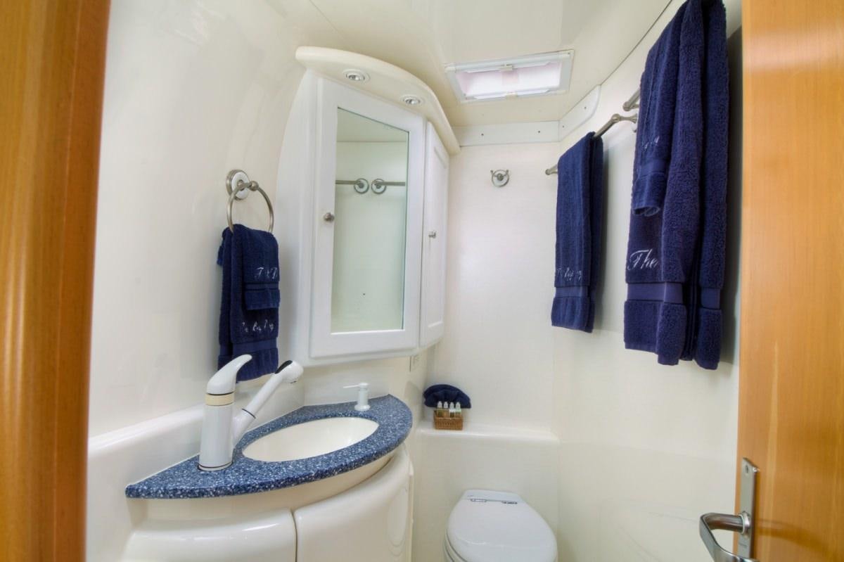 a bathroom with a sink and a mirror aboard THE BIG DOG Yacht for Charter