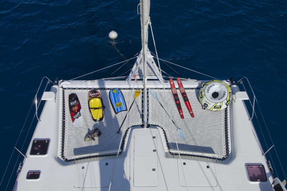 a large white ship with red and yellow flags on it aboard THE BIG DOG Yacht for Charter