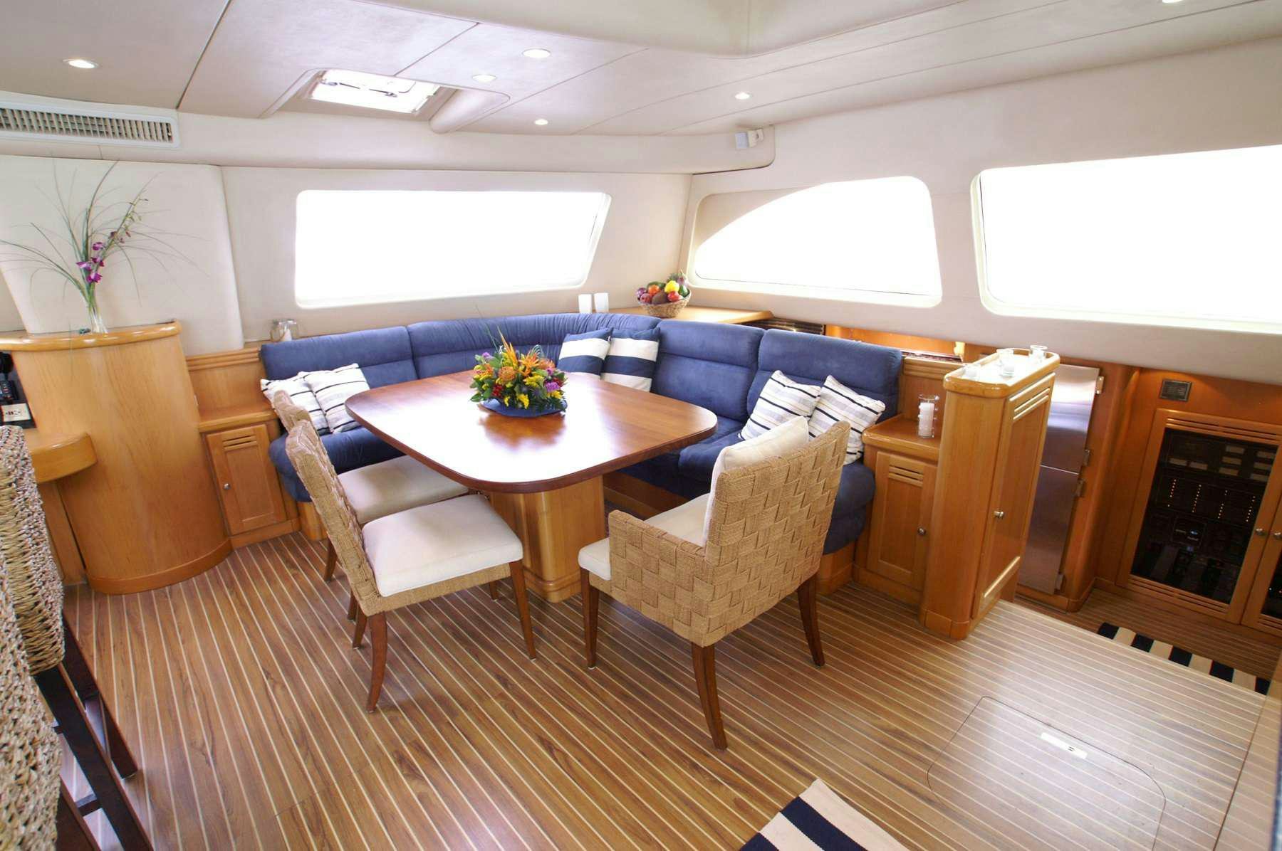 a room with a table chairs and a couch aboard THE BIG DOG Yacht for Charter