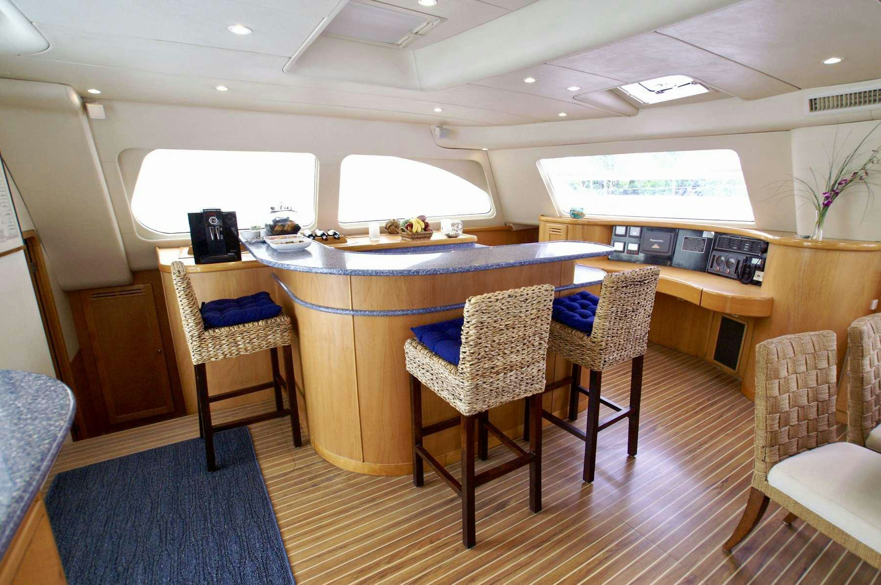 a table with chairs around it aboard THE BIG DOG Yacht for Charter