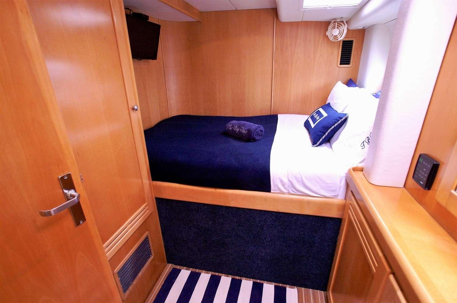 a couple of beds in a room aboard THE BIG DOG Yacht for Charter