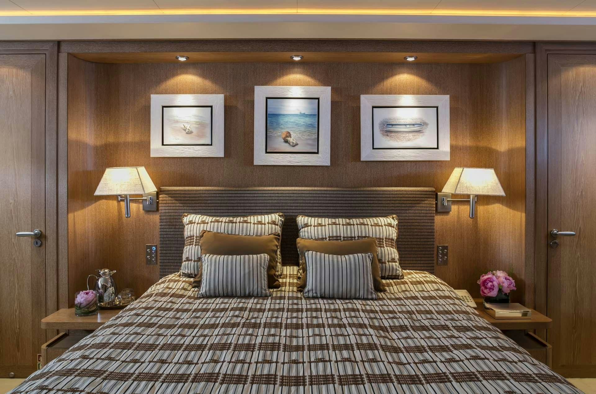 a bed with a large headboard aboard ALEXIA AV Yacht for Charter