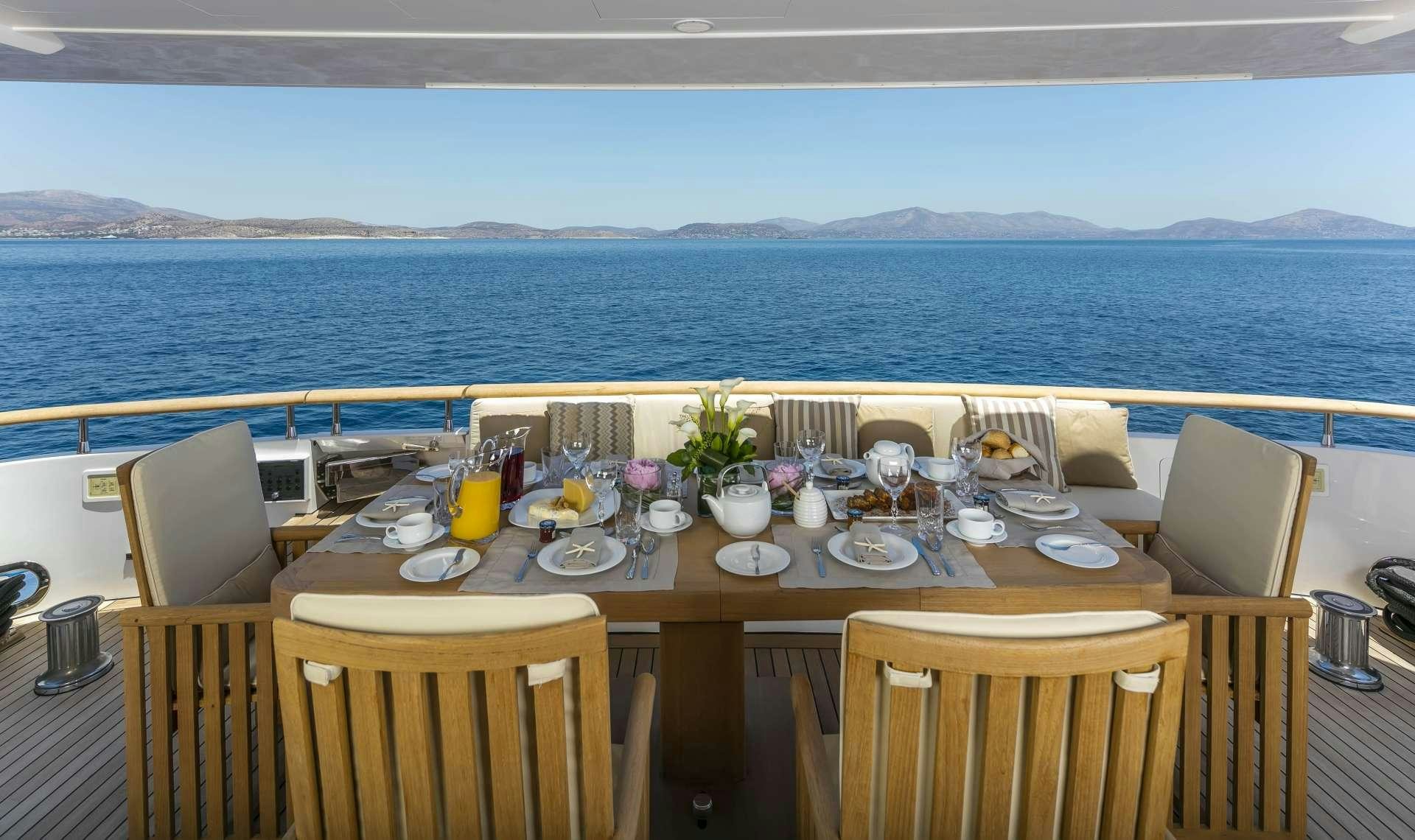 a table set for a dinner aboard ALEXIA AV Yacht for Charter