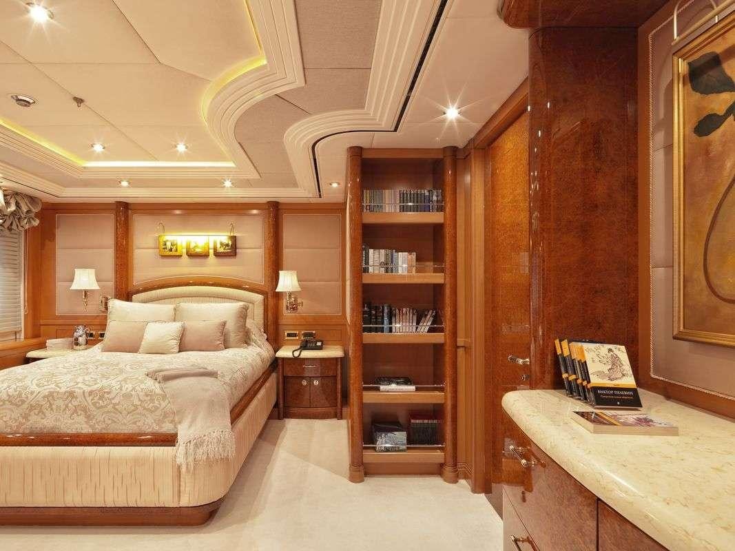 a bedroom with a bookcase and a bed aboard CAPRI I Yacht for Charter