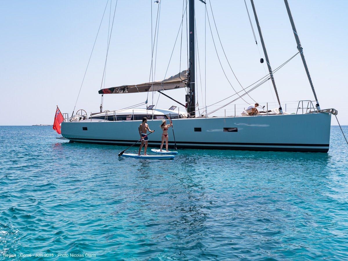 a couple of people on a sailboat aboard NEYINA Yacht for Charter