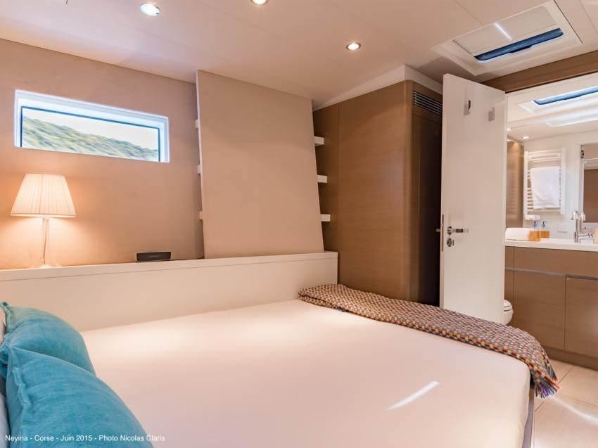 a bedroom with a bed and a desk aboard NEYINA Yacht for Charter