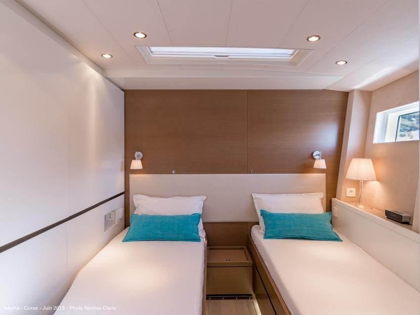 a room with two beds aboard NEYINA Yacht for Charter