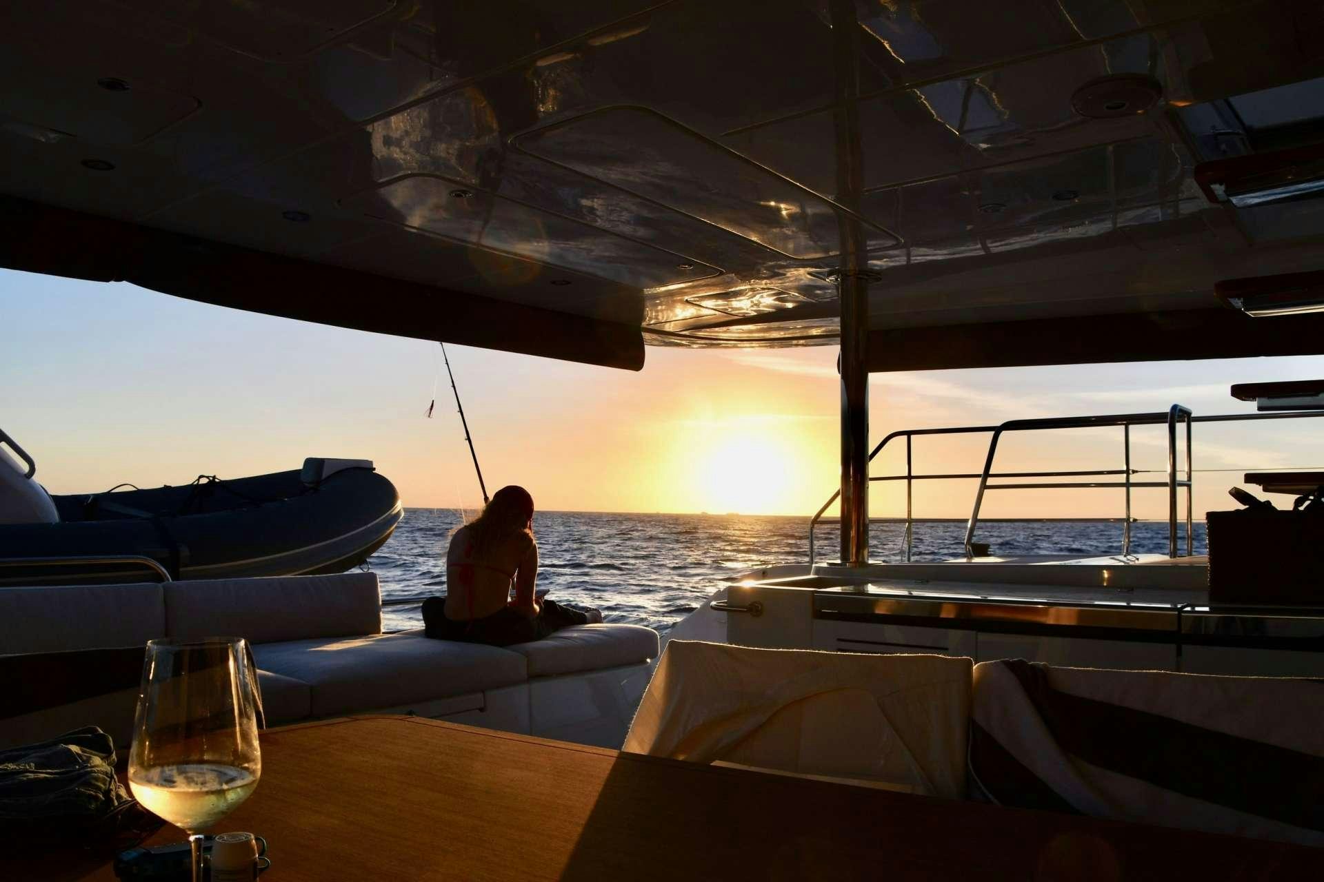 a person sitting on a boat aboard LONG MONDAY Yacht for Charter