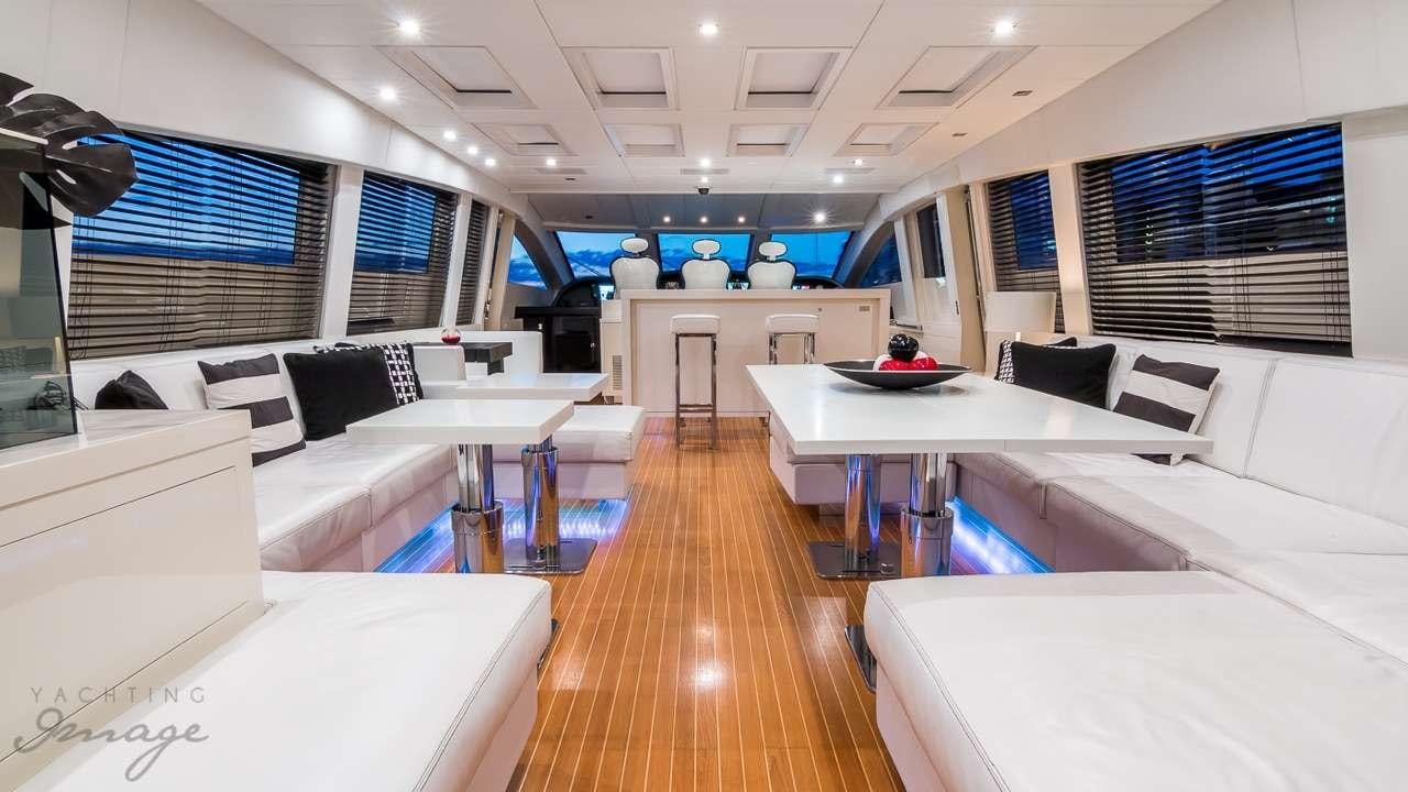 a room with a table and couches aboard FRIDAY Yacht for Charter