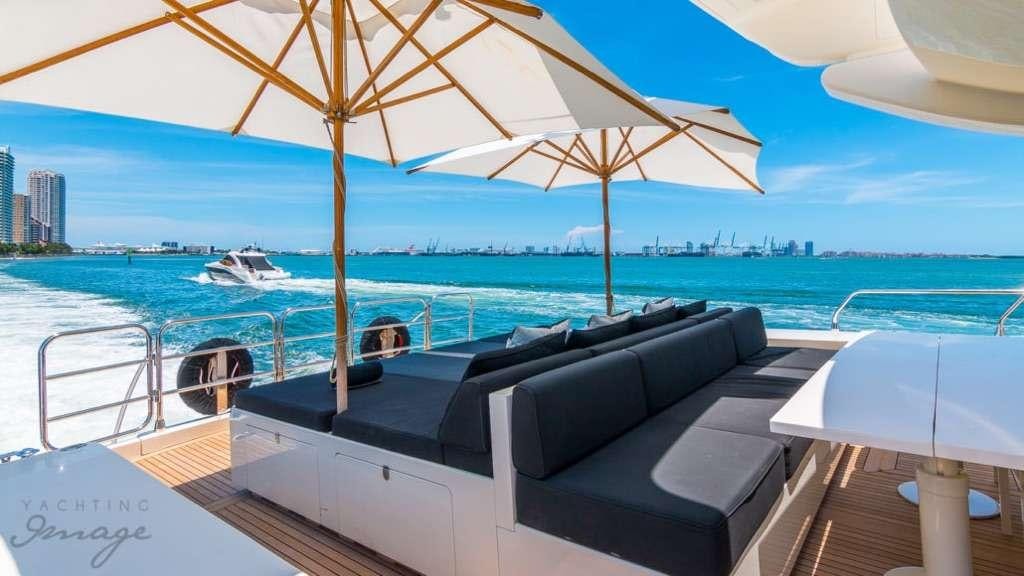 a lounge chair and umbrella on a boat aboard FRIDAY Yacht for Charter