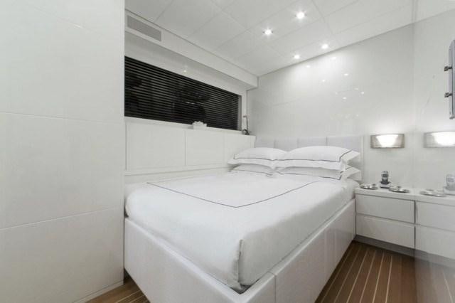 a white bed in a room aboard FRIDAY Yacht for Charter