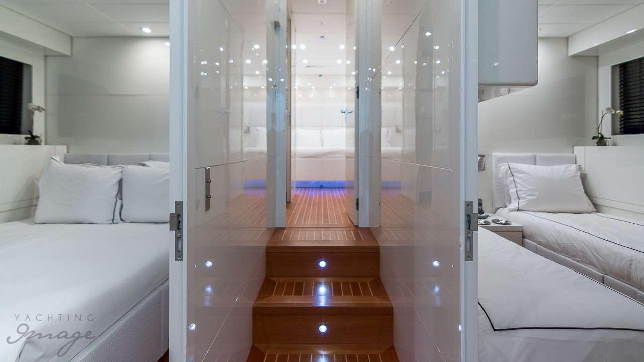 a room with a bed and a mirror aboard FRIDAY Yacht for Charter