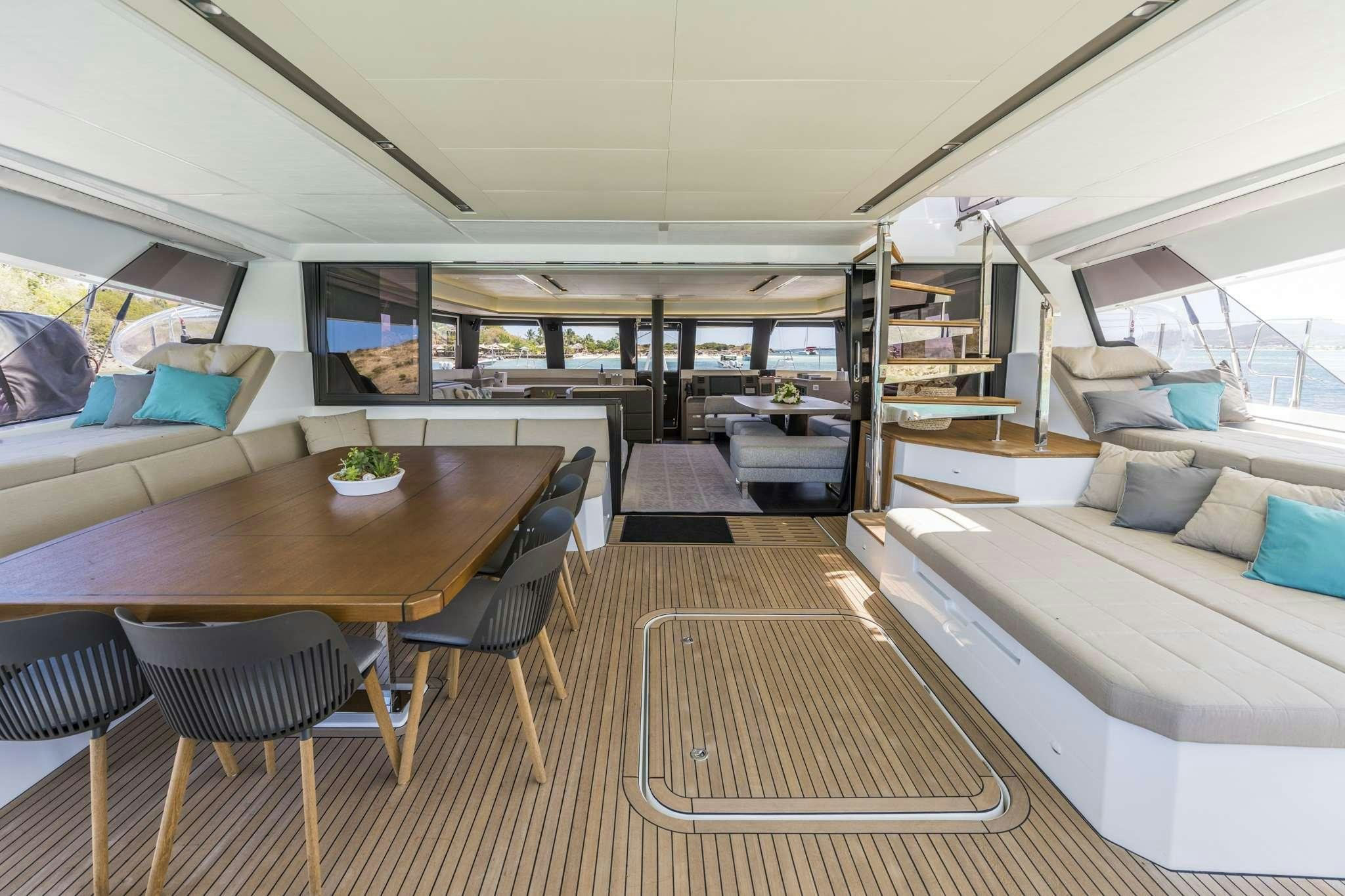 a room with a table and chairs aboard LISA OF THE SEAS Yacht for Charter