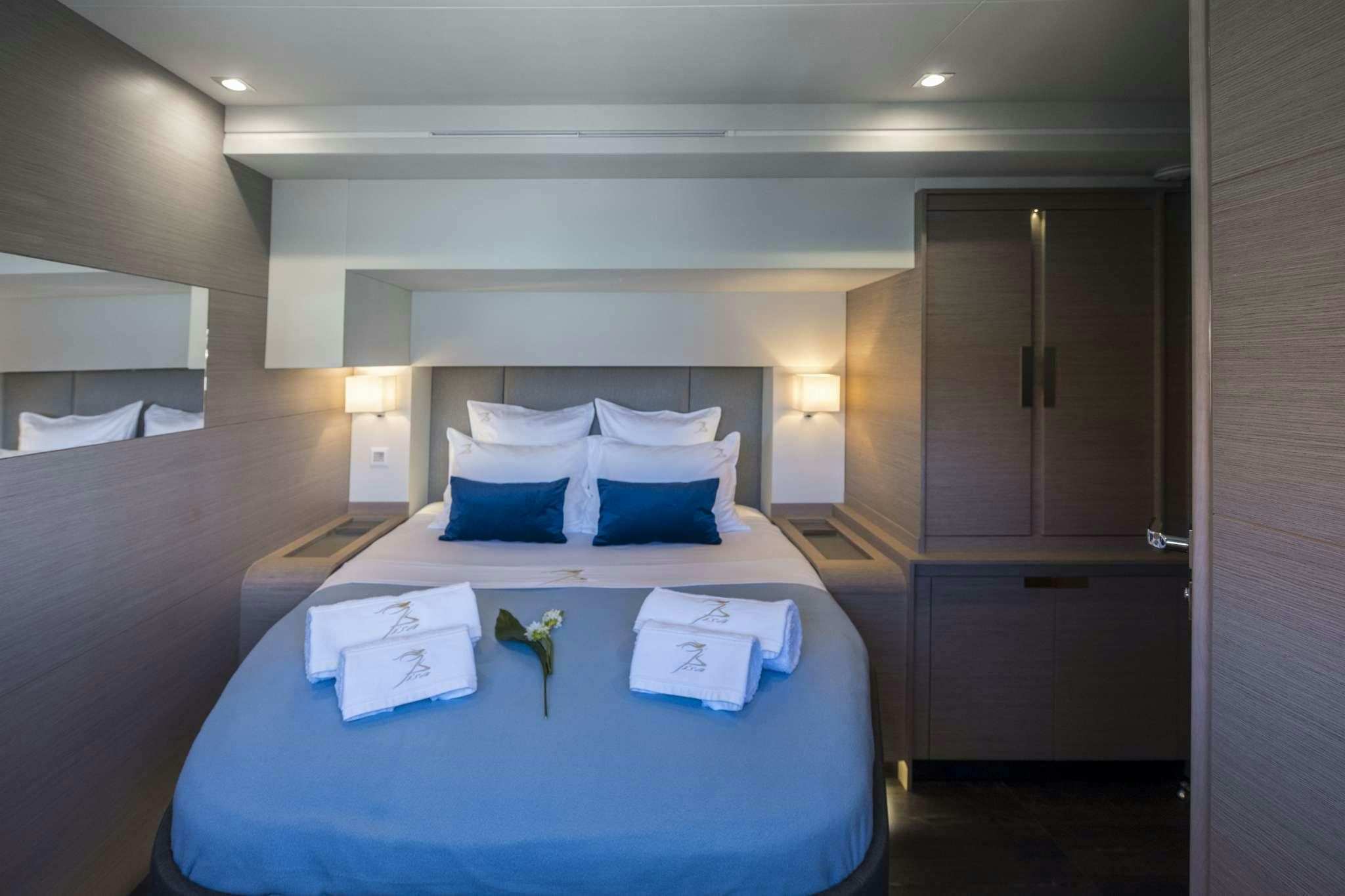 a hotel room with a bed and a desk aboard LISA OF THE SEAS Yacht for Charter