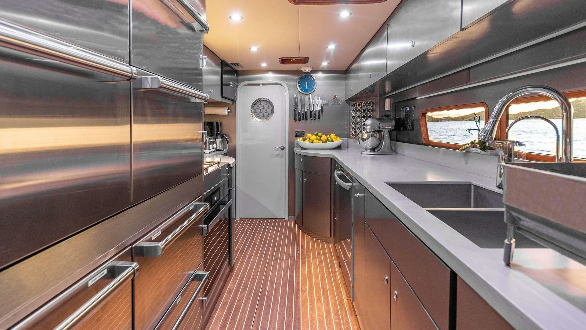 a kitchen with stainless steel appliances aboard SUR L'EAU Yacht for Charter