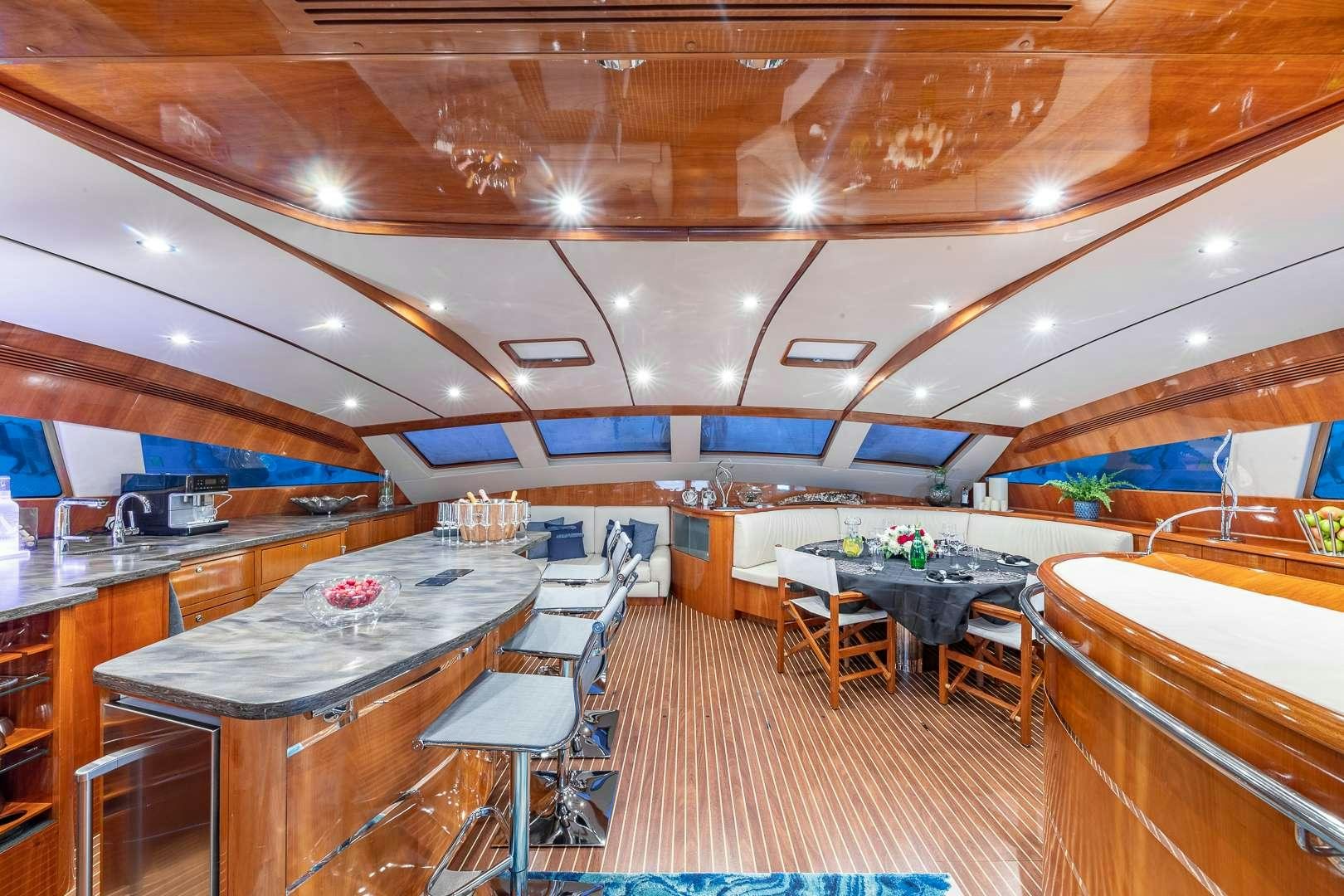 a room with tables and chairs aboard SUR L'EAU Yacht for Charter