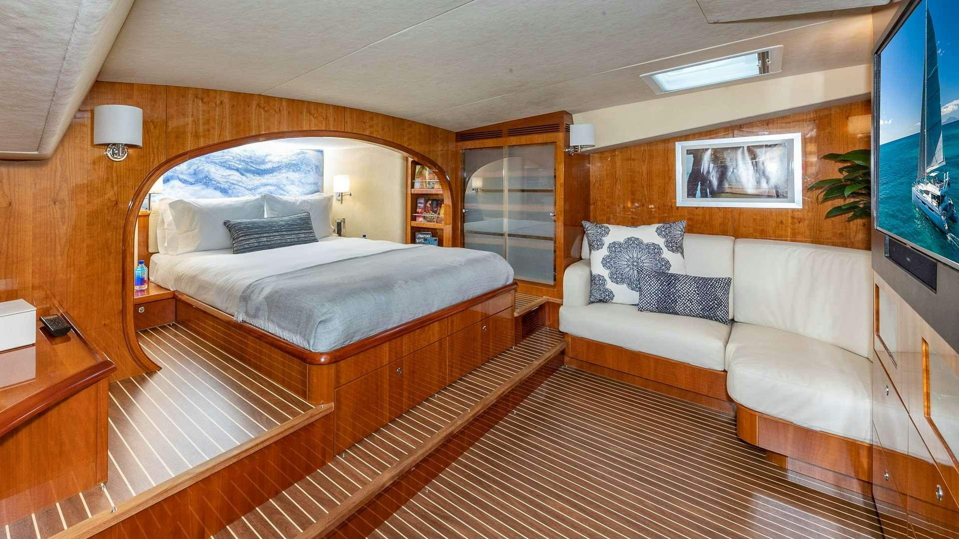 a hotel room with a bed and a television aboard SUR L'EAU Yacht for Charter