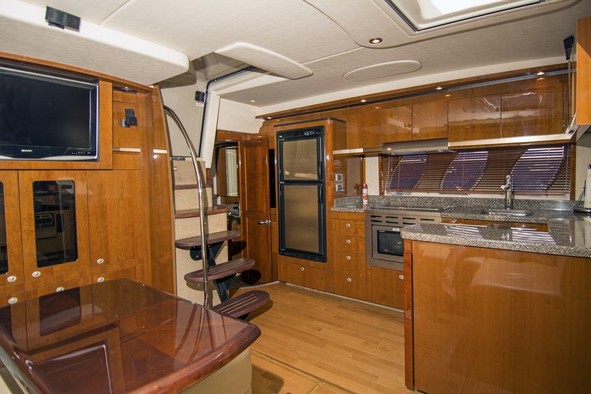 a kitchen with wooden cabinets aboard PIER PRESSURE Yacht for Charter