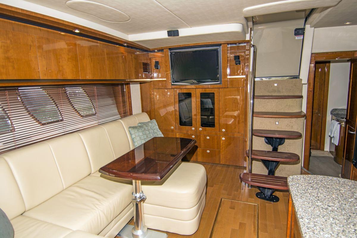 a living room with a couch and a television aboard PIER PRESSURE Yacht for Charter