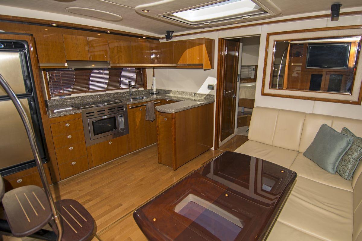 a kitchen with a table and chairs aboard PIER PRESSURE Yacht for Charter
