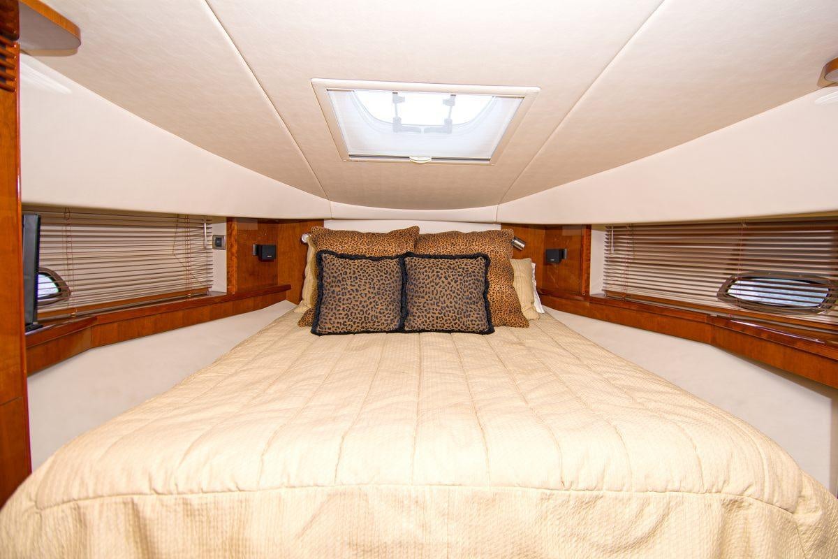 a bed with a white comforter aboard PIER PRESSURE Yacht for Charter