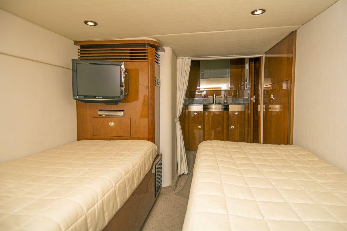 a hotel room with a bed and tv aboard PIER PRESSURE Yacht for Charter