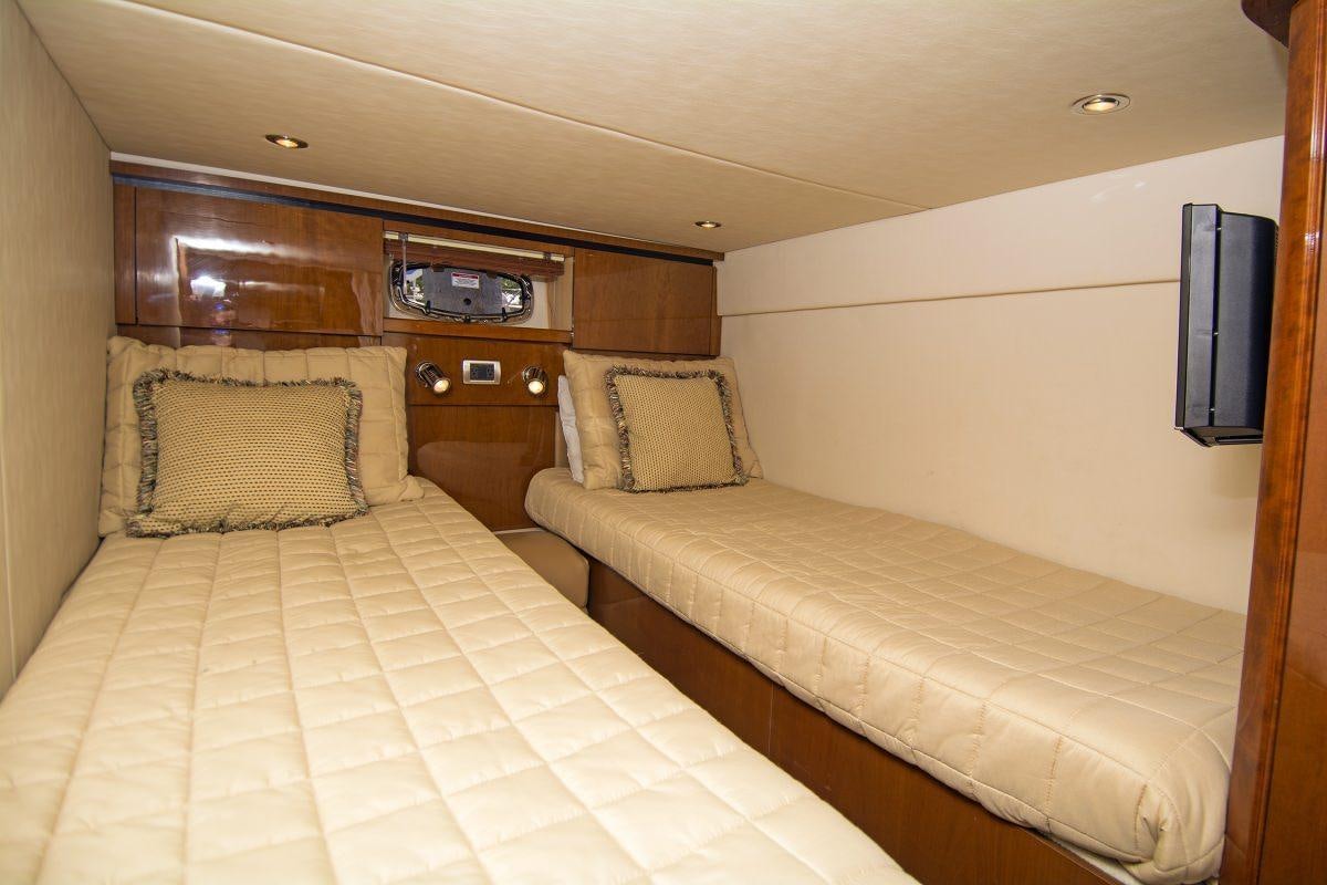 a bed with a television on the wall aboard PIER PRESSURE Yacht for Charter