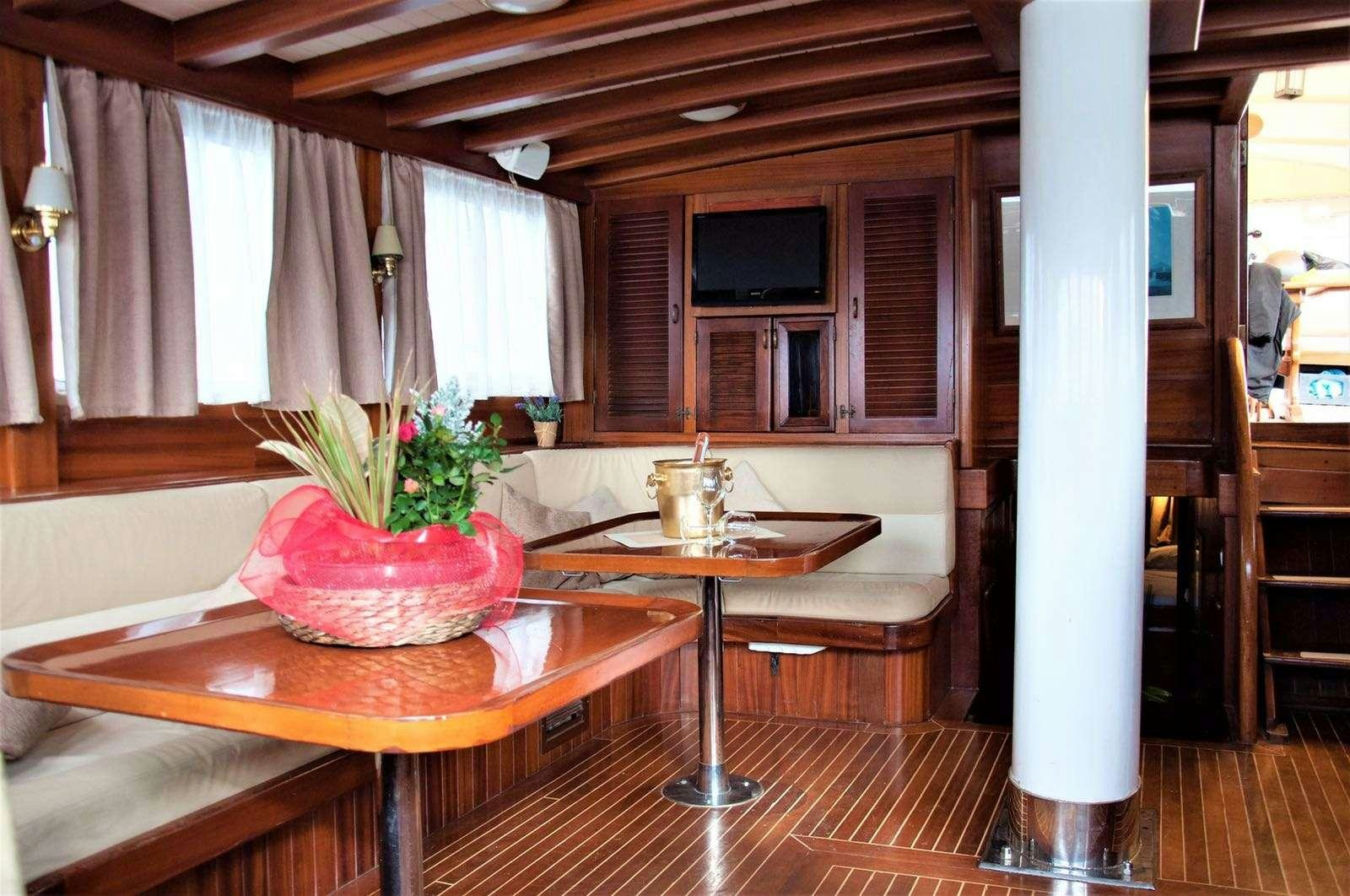 a kitchen with a table and chairs aboard Donna Marisa Yacht for Charter