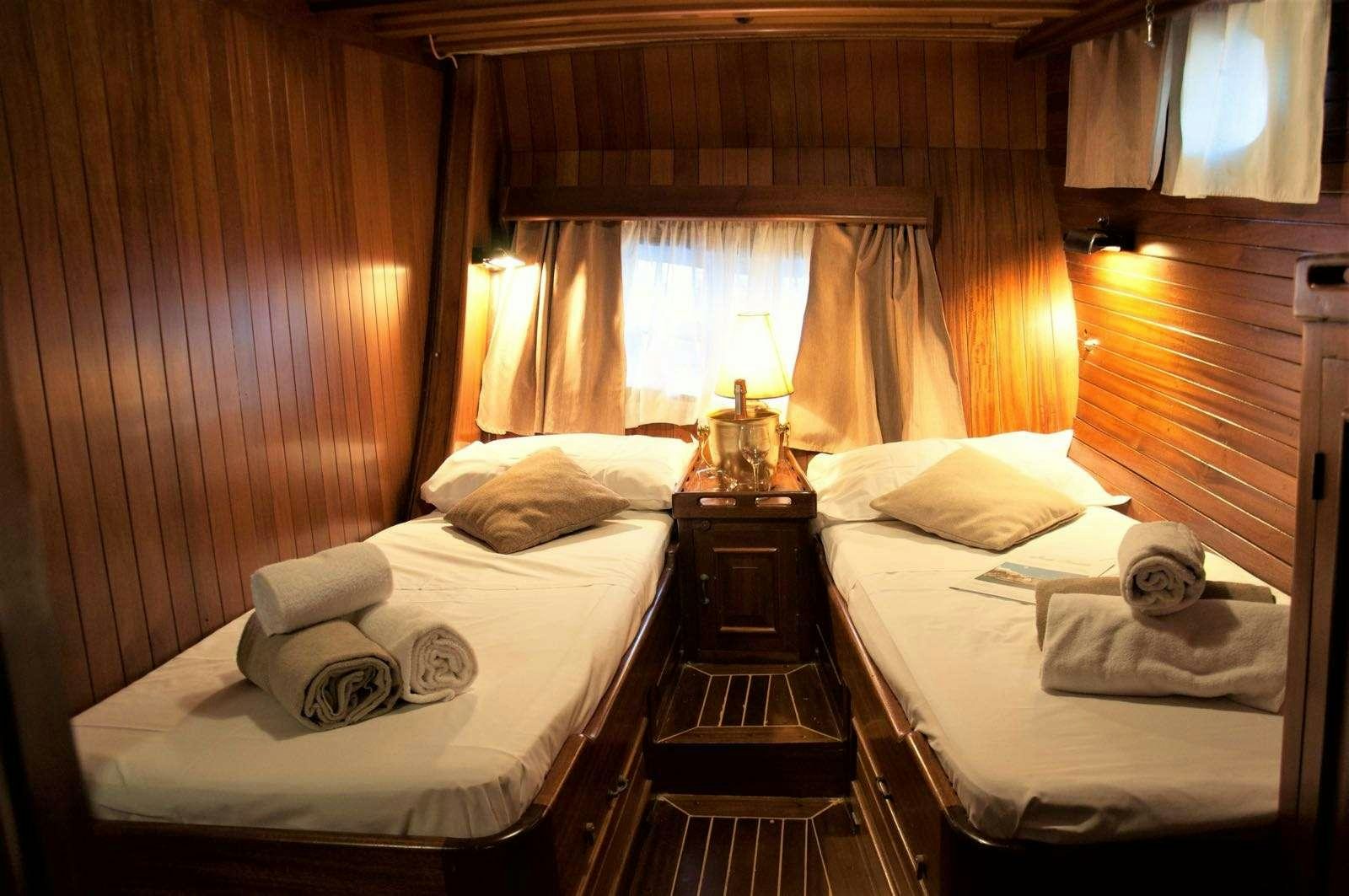 a couple of beds in a room aboard Donna Marisa Yacht for Charter