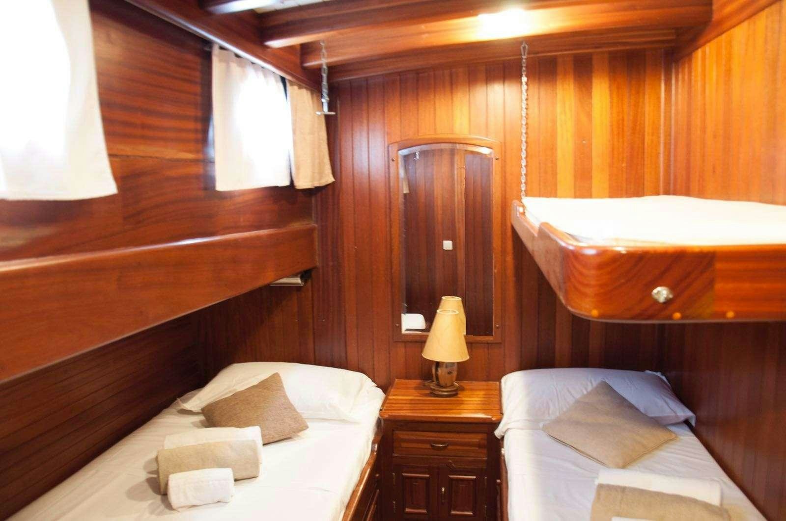 a room with a bed and a lamp aboard Donna Marisa Yacht for Charter
