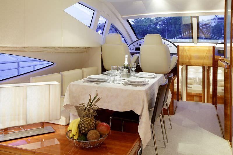 a table with chairs and fruit on it aboard GEORGE V Yacht for Charter