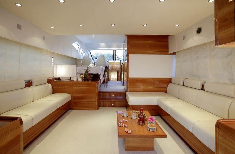 a living room with a couch and a table aboard GEORGE V Yacht for Charter
