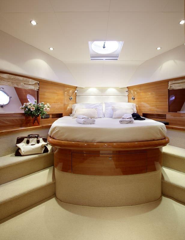 a bed with a white bed aboard GEORGE V Yacht for Charter