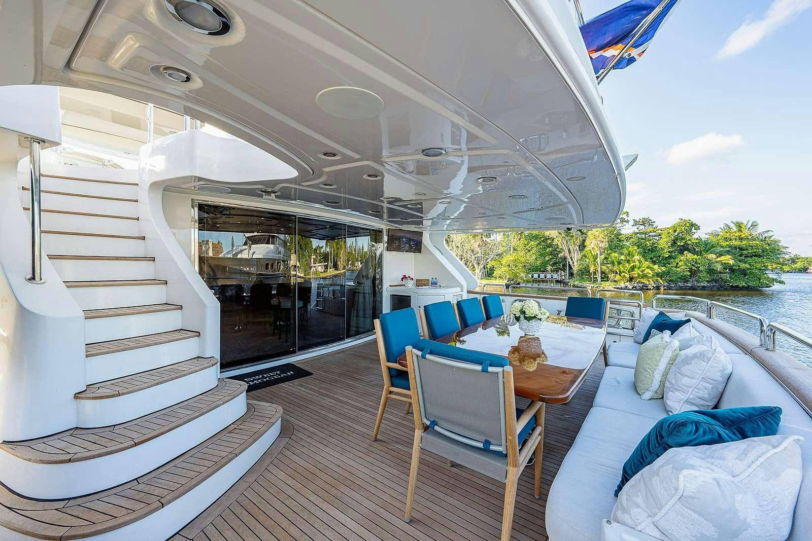a boat with a table and chairs aboard SWEET EMOCEAN Yacht for Charter