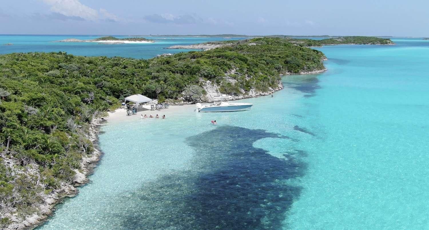 a beach with a clear blue ocean aboard SWEET EMOCEAN Yacht for Charter