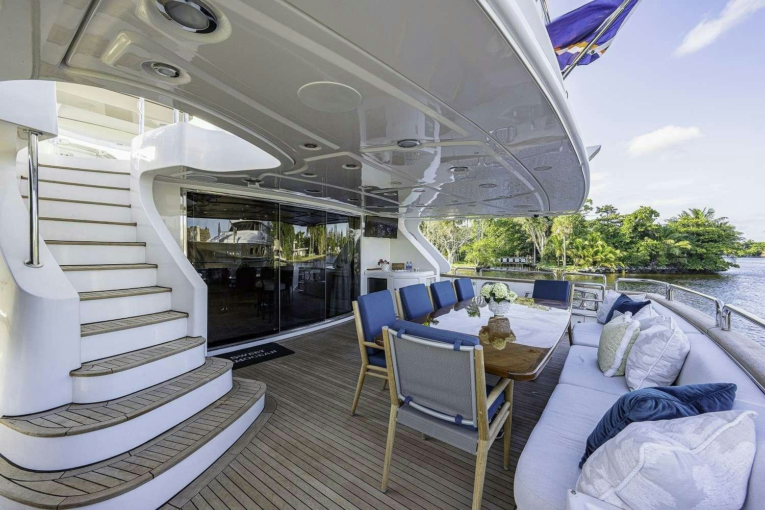 a boat with a table and chairs aboard SWEET EMOCEAN Yacht for Charter