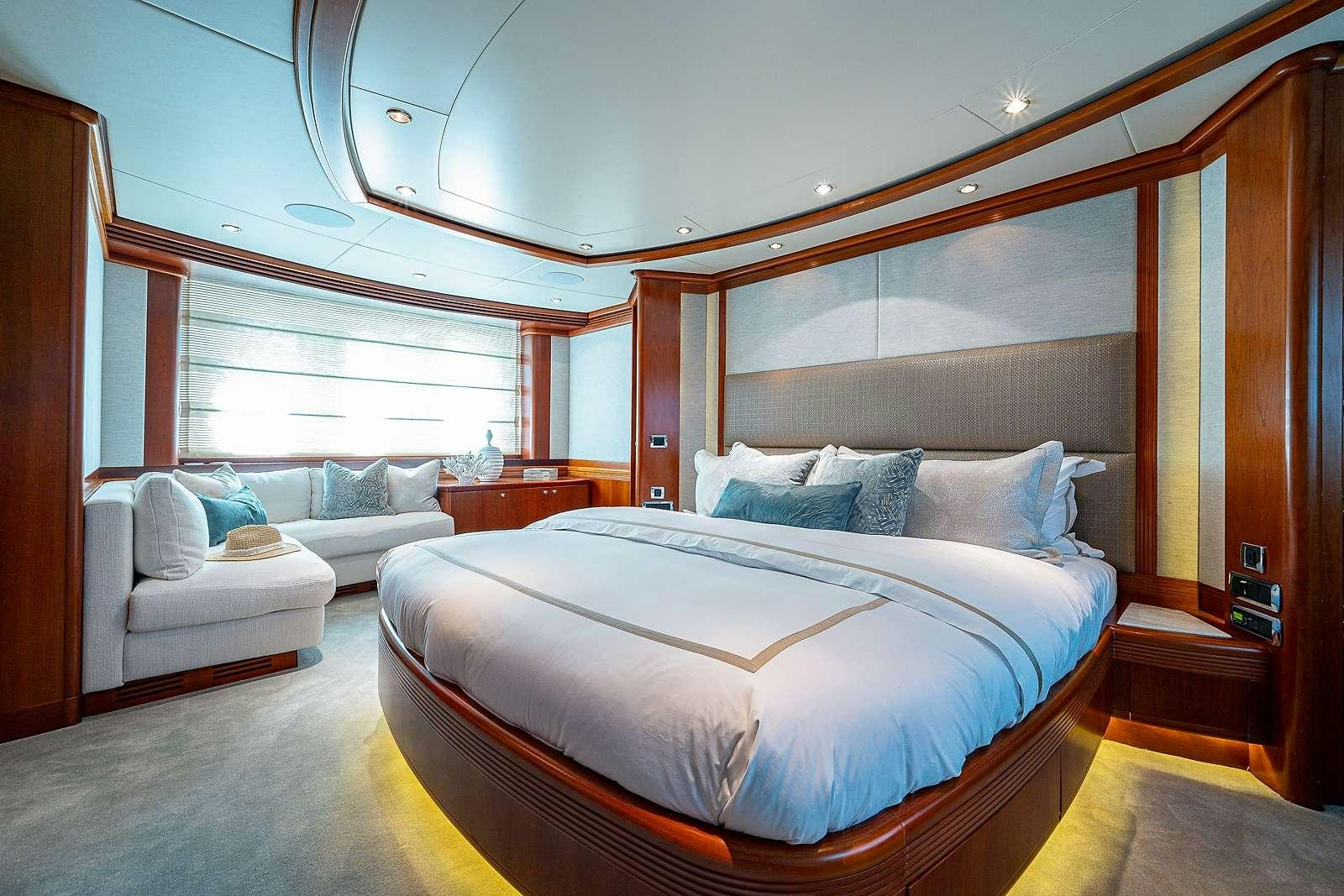 a room with a bed and a couch aboard SWEET EMOCEAN Yacht for Charter