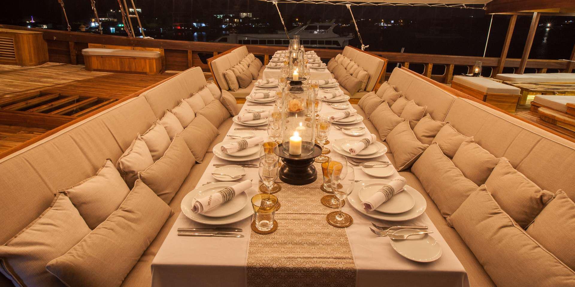 a table set with plates and glasses aboard PRANA Yacht for Charter