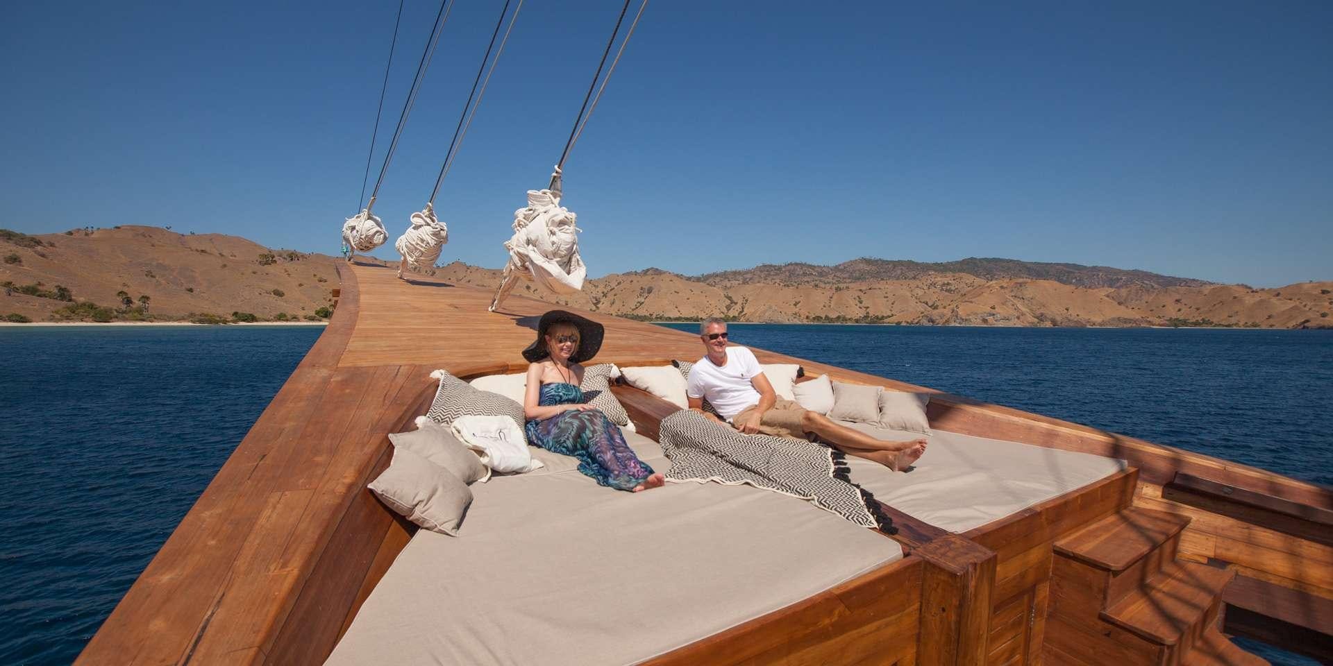 a man and woman on a boat aboard PRANA Yacht for Charter