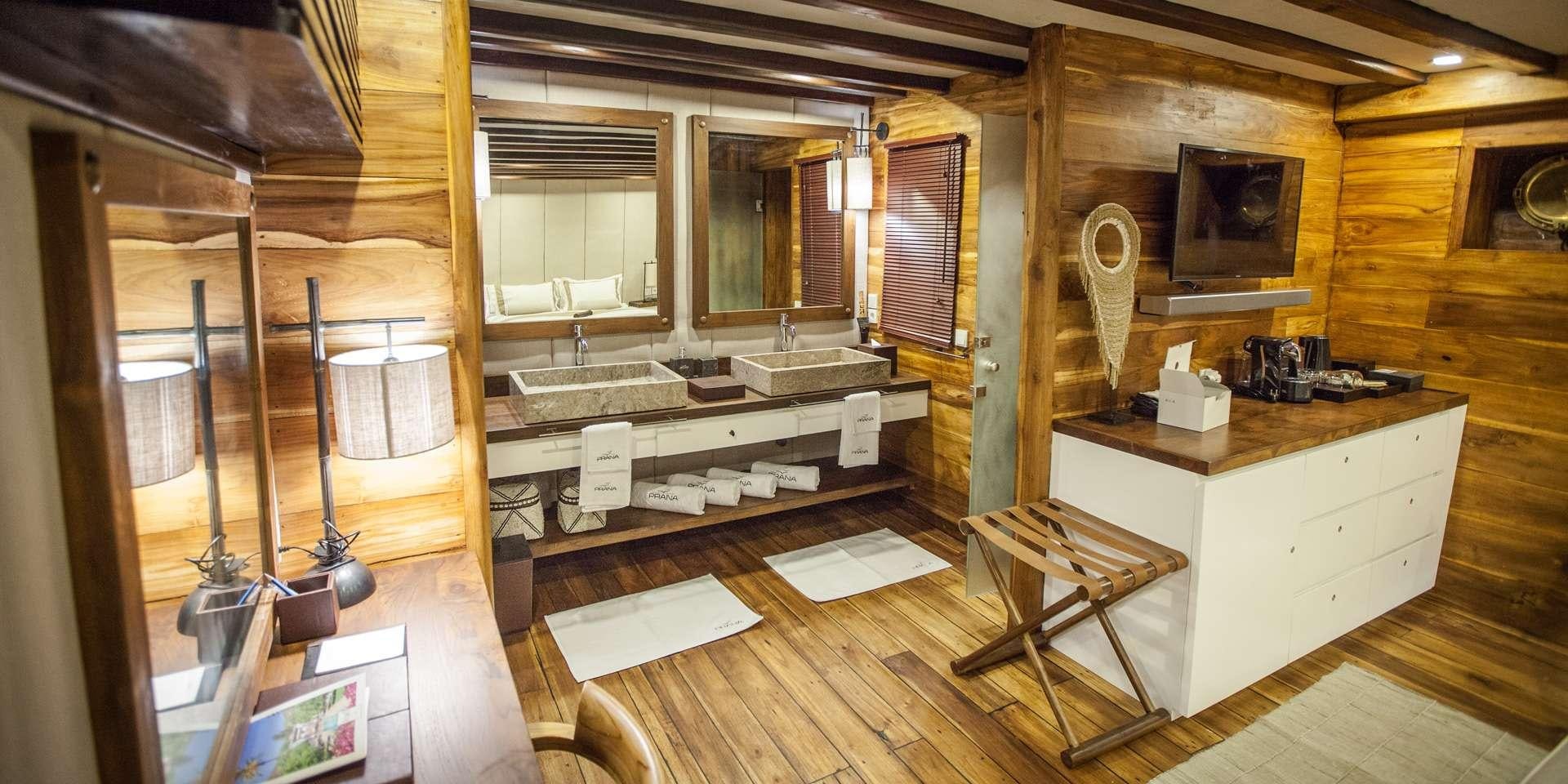 a room with a desk and a mirror aboard PRANA Yacht for Charter