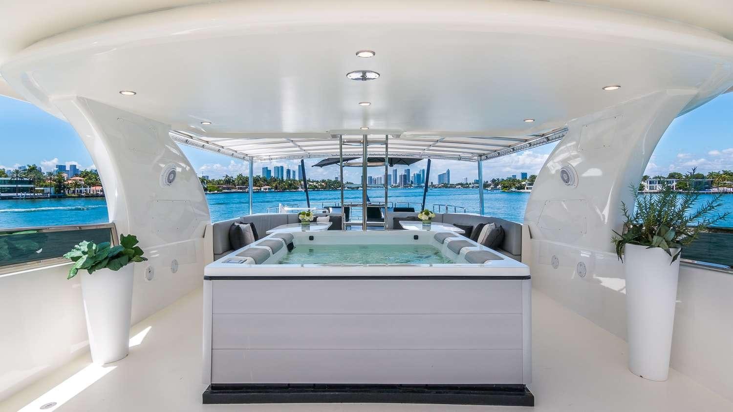 a large white lounge chair next to a pool and a large white lounge chair aboard NIRVANA Yacht for Charter