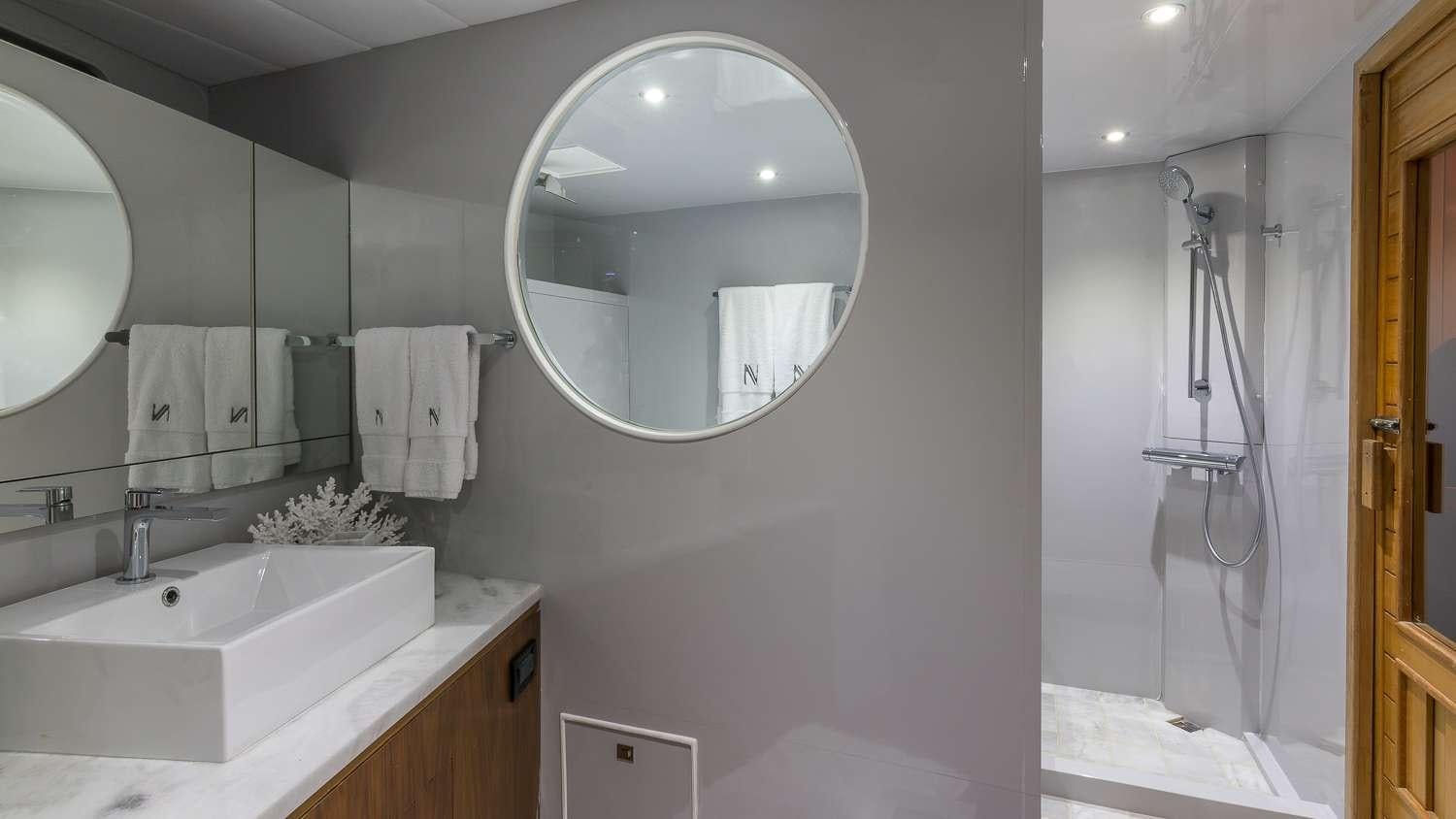 a bathroom with a large mirror aboard NIRVANA Yacht for Charter