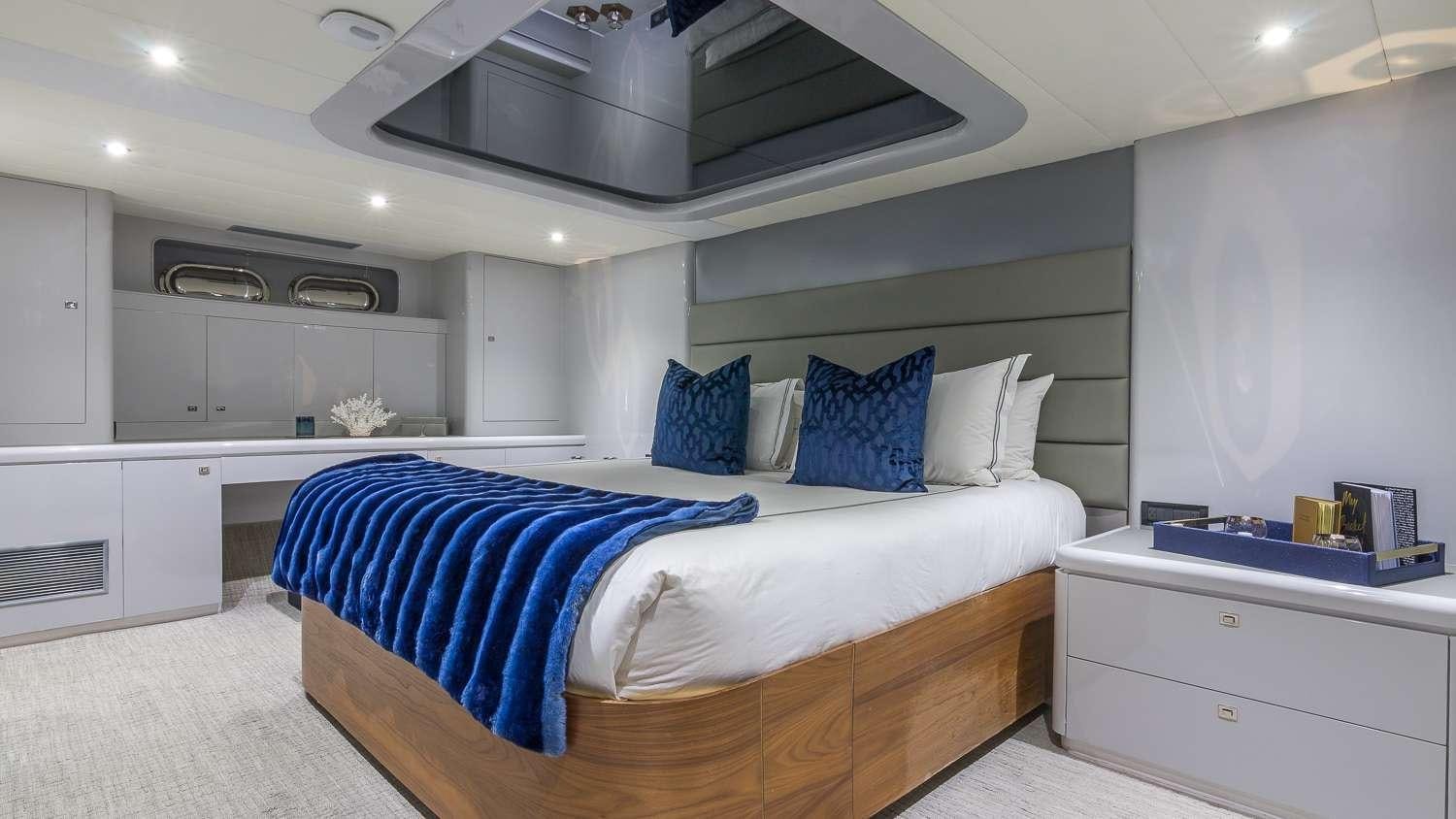 a bedroom with a bed and a sink aboard NIRVANA Yacht for Charter