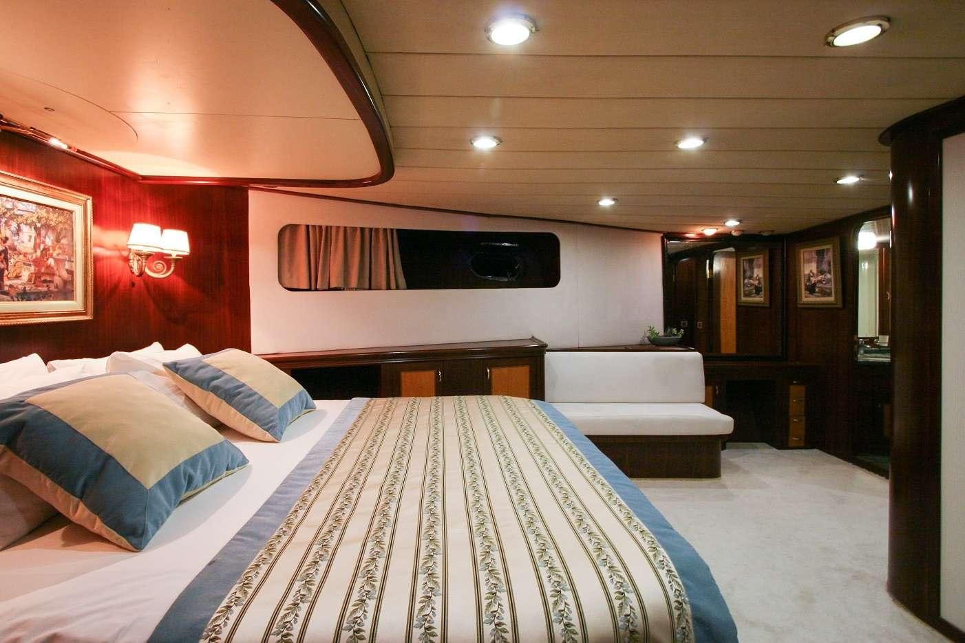 a room with a bed and a television aboard CANEREN Yacht for Charter