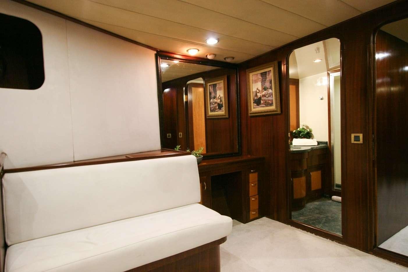 a room with a couch and a mirror aboard CANEREN Yacht for Charter