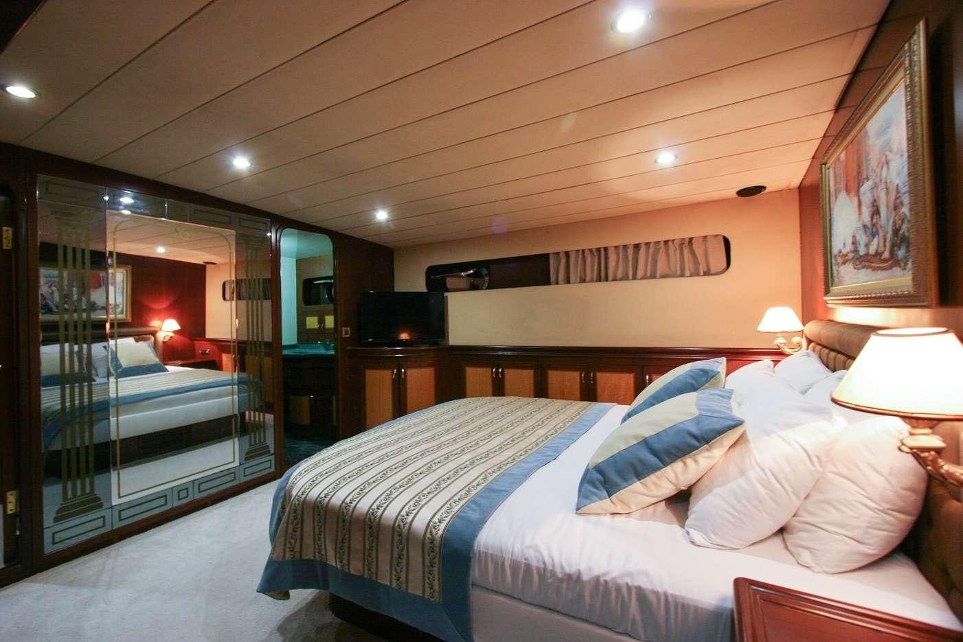 a bedroom with a glass wall aboard CANEREN Yacht for Charter
