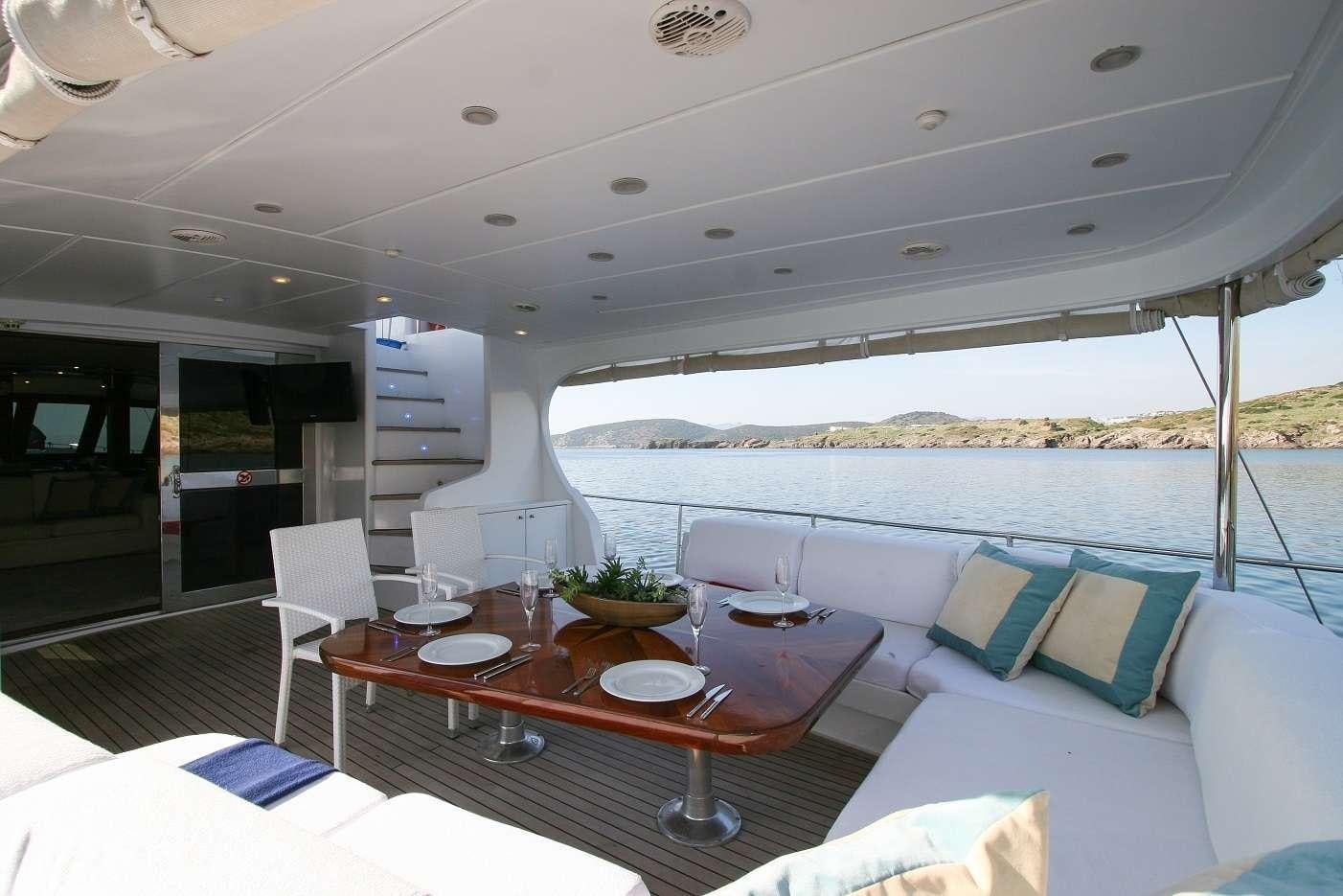 a living room with a large balcony aboard CANEREN Yacht for Charter