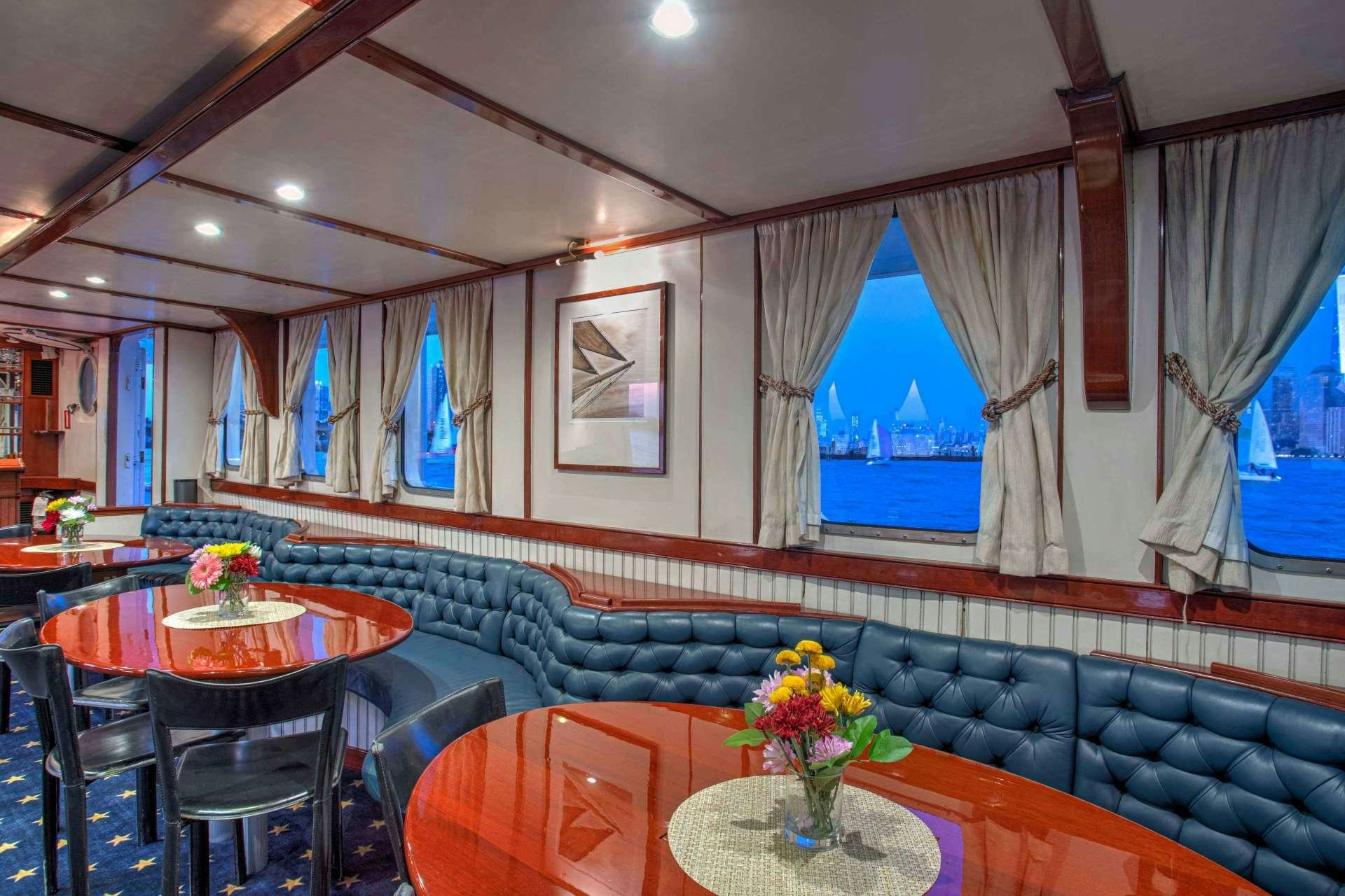a room with a table and chairs aboard ARABELLA II Yacht for Charter