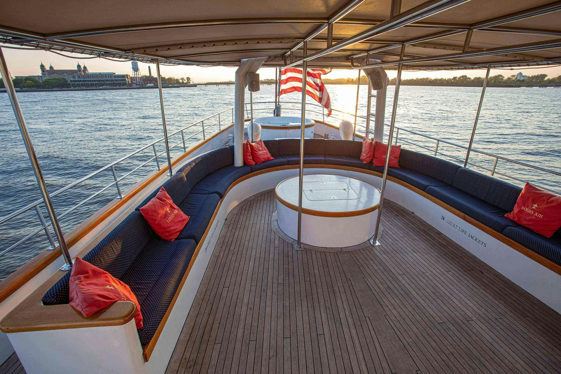 a boat with a flag on the front aboard ARABELLA II Yacht for Charter